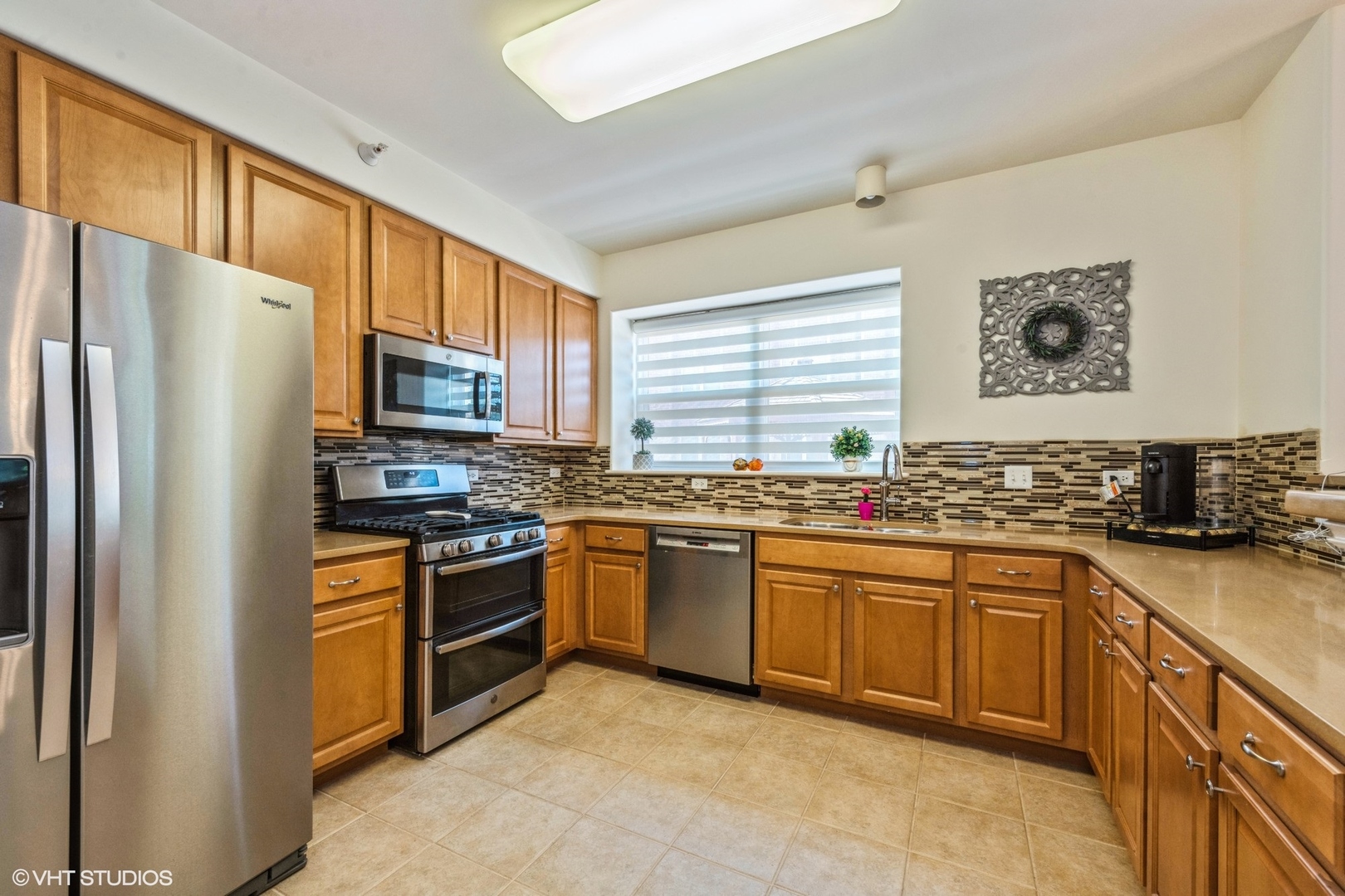 1 Itasca Road, Unit 101 Itasca, IL 60143 - Photo 6 of 21 a kitchen with stainless steel appliances granite countertop a refrigerator a stove top oven a sink and dishwasher