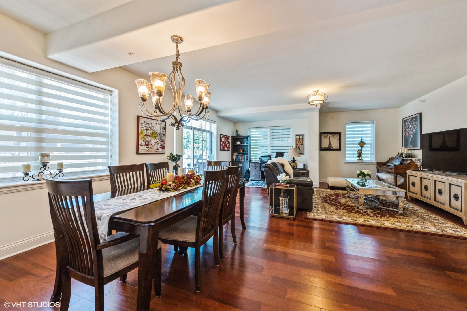 1 Itasca Road, Unit 101 Itasca, IL 60143 - Photo 10 of 21 a view of a dining room with furniture a chandelier and wooden floor