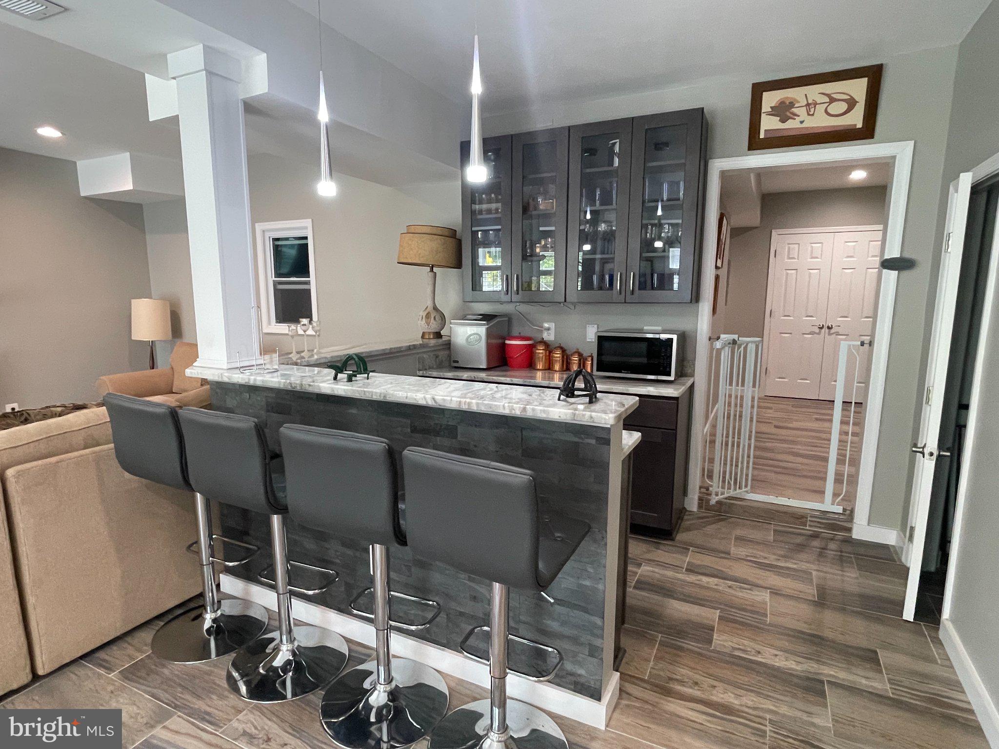 7747 Riverside Farm Road Marshall, VA 20115 - Photo 29 of 69 Modern kitchen with sleek bar seating.