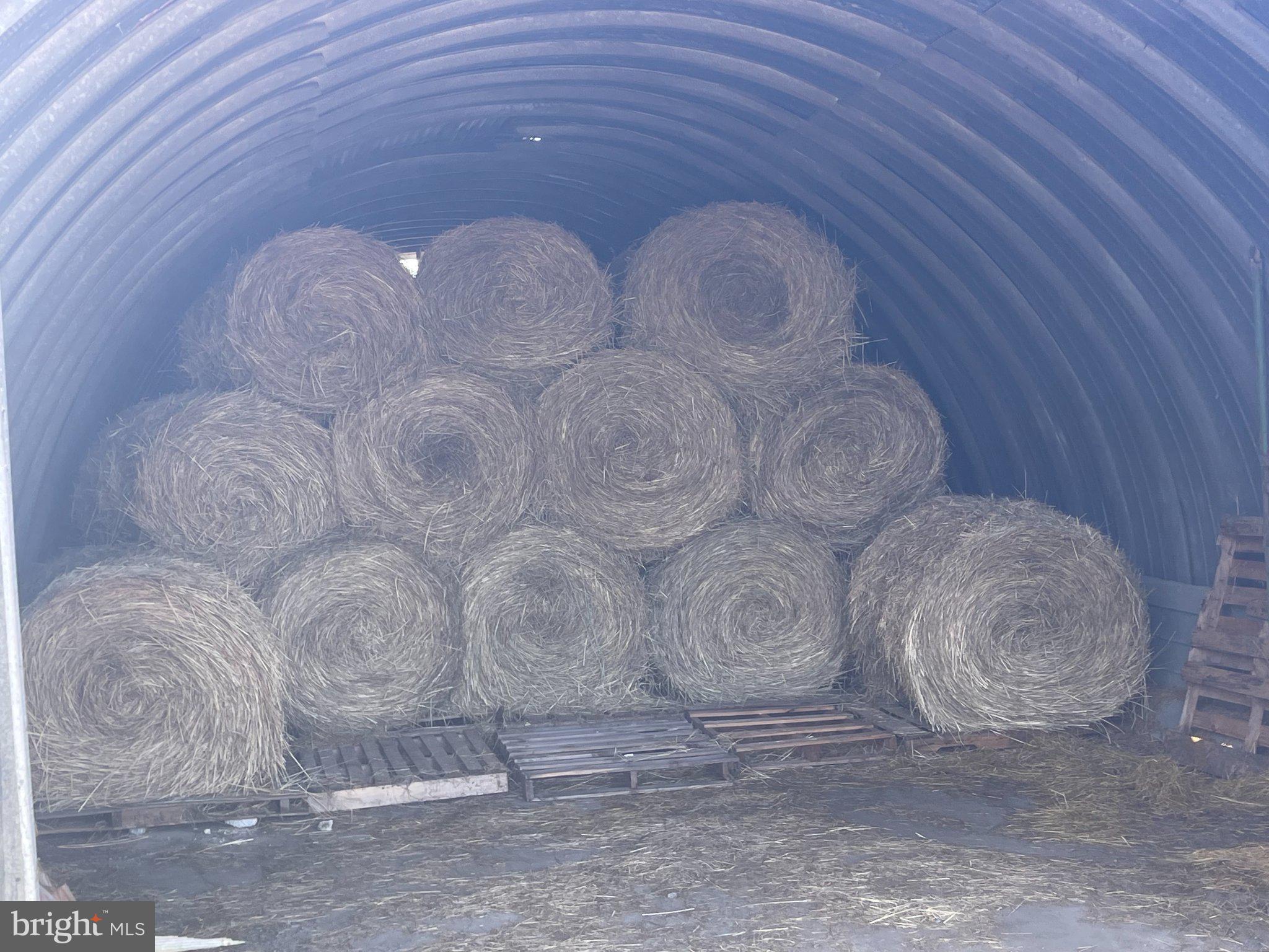 7747 Riverside Farm Road Marshall, VA 20115 - Photo 55 of 69 Hay bales stacked in a barn.