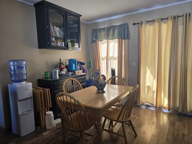 a living room with furniture a large window and a fireplace