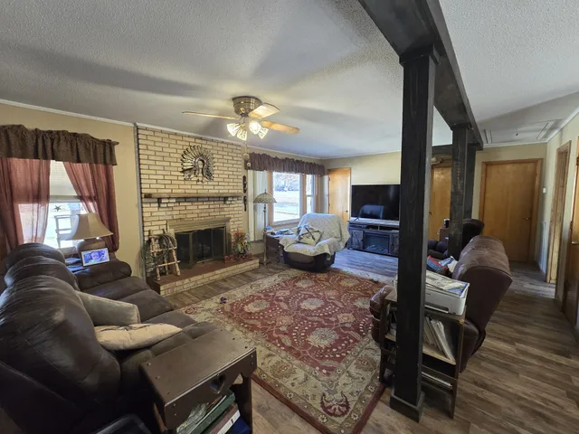 a living room with furniture a fireplace and a flat screen tv