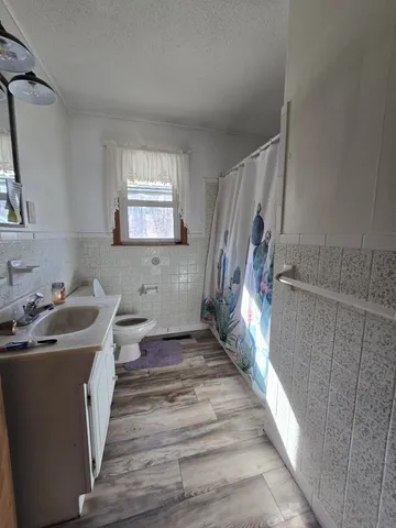 a bedroom with bed and a chandelier