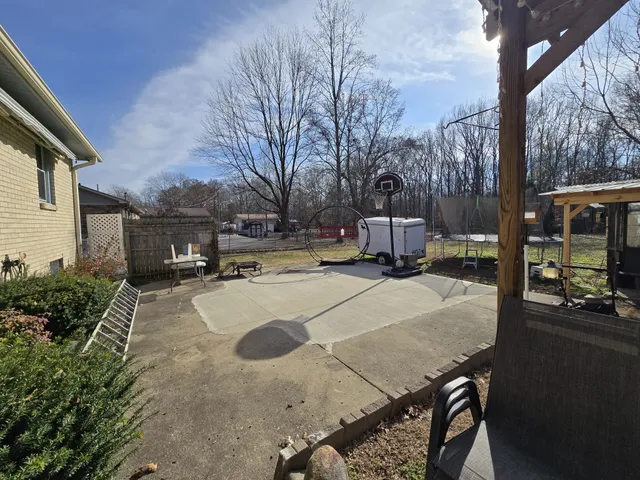 a living room with furniture a chandelier and a flat screen tv