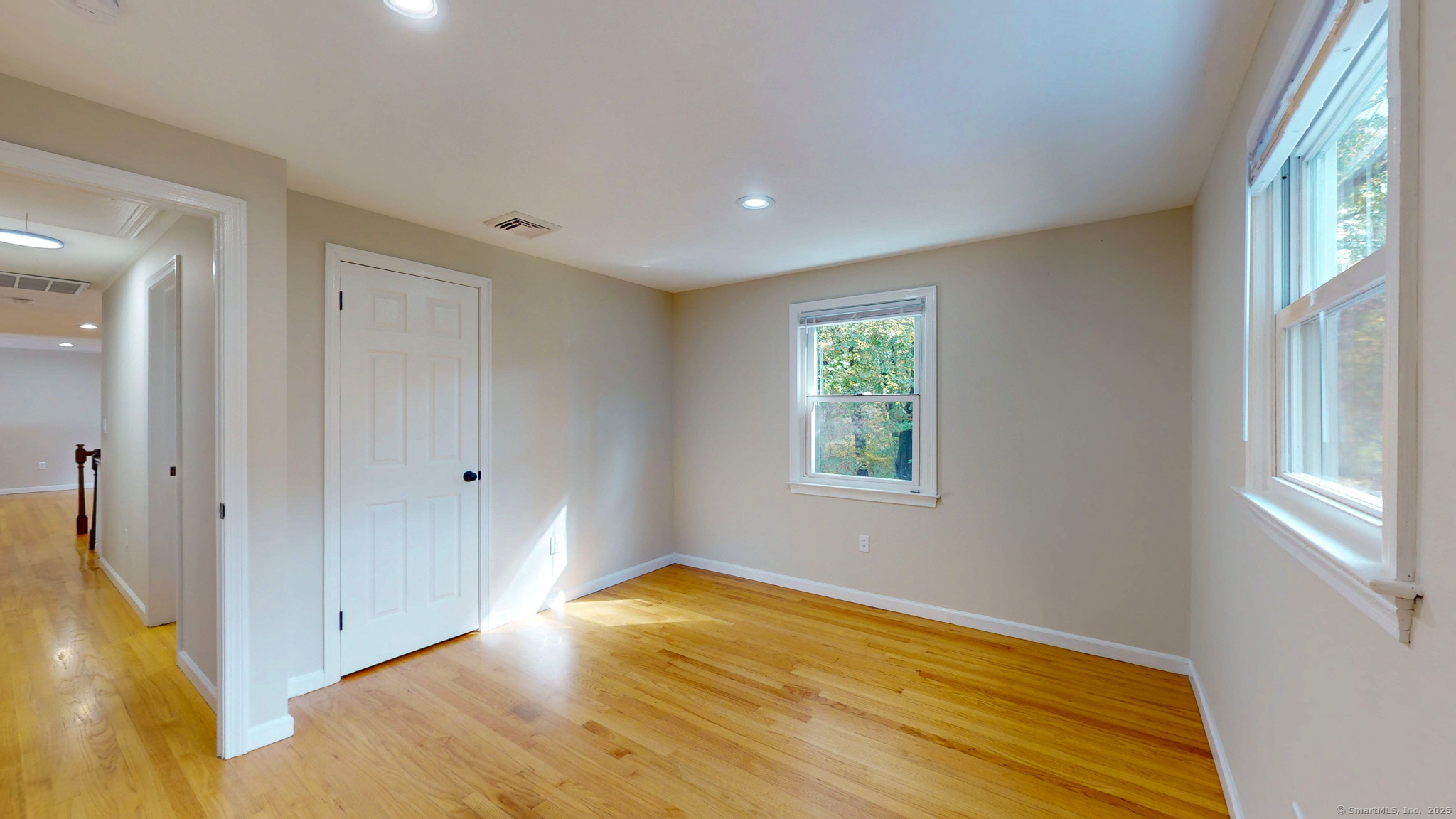 9 Old Farms Road Madison, CT 06443 - Photo 19 of 36 a view of empty room with window and wooden floor