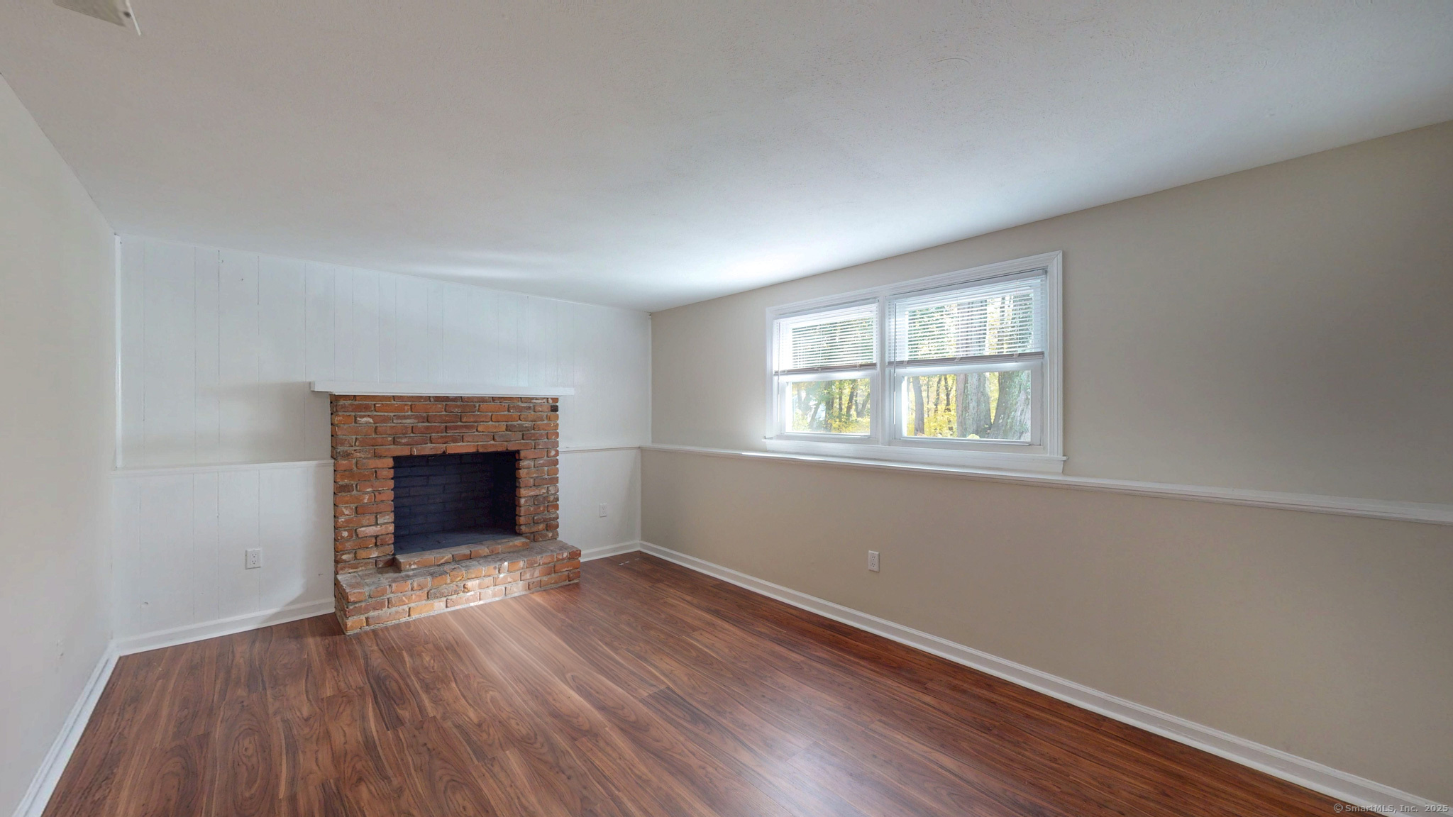 9 Old Farms Road Madison, CT 06443 - Photo 23 of 36 an empty room with wooden floor fireplace and windows