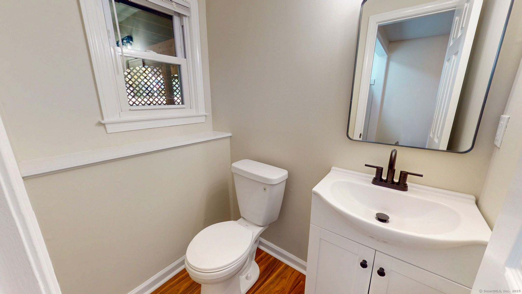 9 Old Farms Road Madison, CT 06443 - Photo 27 of 36 a bathroom with a toilet sink and mirror
