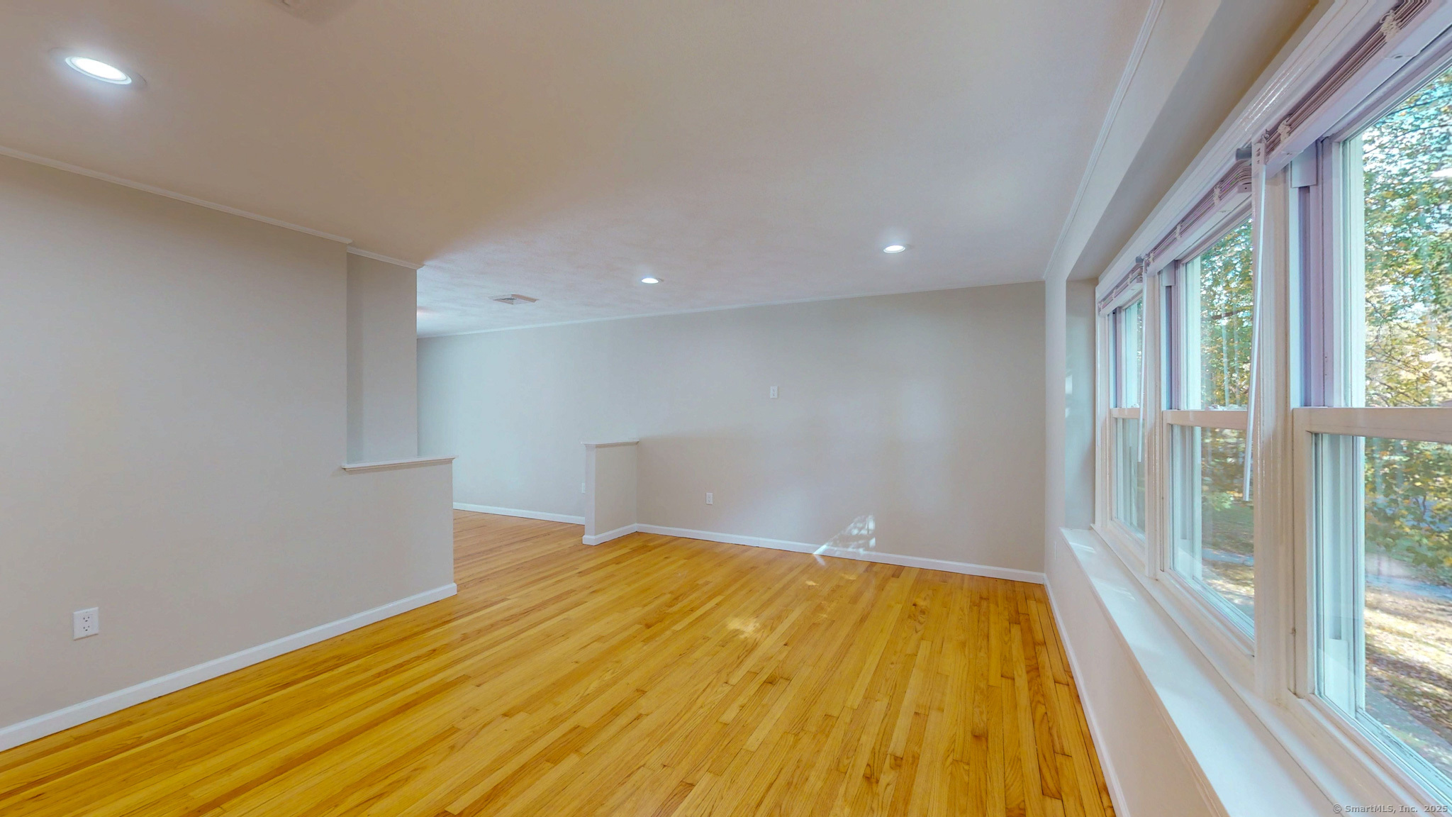 9 Old Farms Road Madison, CT 06443 - Photo 6 of 36 a view of empty room with wooden floor and fan