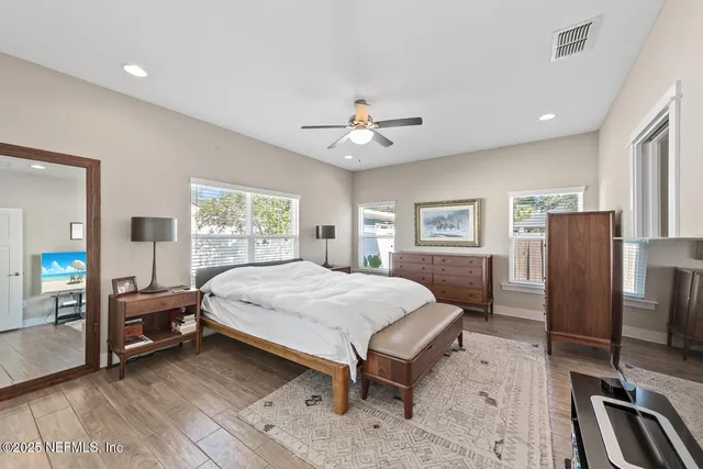 a spacious bedroom with a bed and a chandelier
