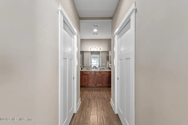 a view of hallway with wooden floor