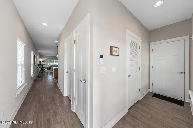 a view of a hallway with wooden floor