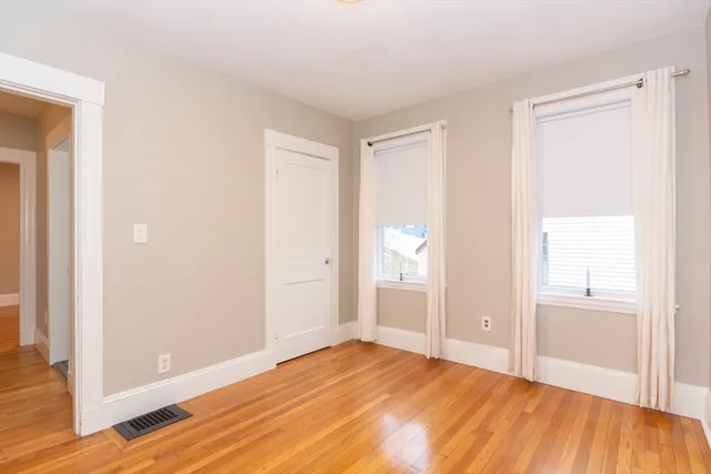 a view of room with window and wooden floor