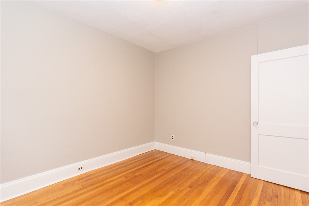 39 Gould Street, Unit A Wakefield, MA 01880 - Photo 19 of 32 a view of empty room with wooden floor