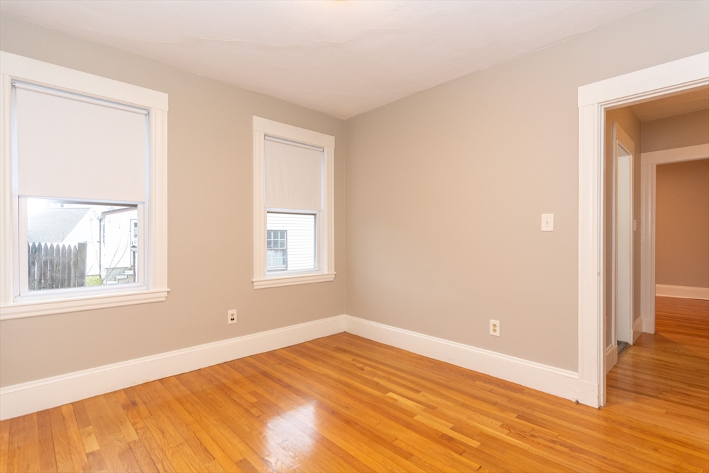 39 Gould Street, Unit A Wakefield, MA 01880 - Photo 23 of 32 a view of an empty room with wooden floor and a window