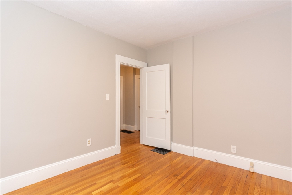39 Gould Street, Unit A Wakefield, MA 01880 - Photo 24 of 32 a view of an empty room with wooden floor