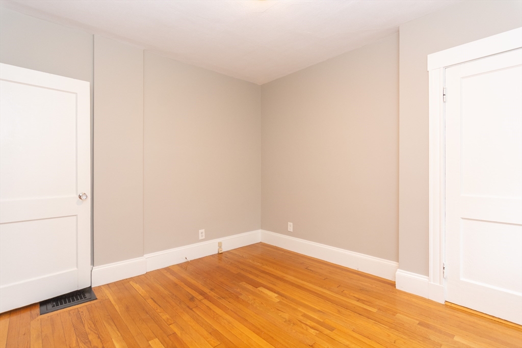 39 Gould Street, Unit A Wakefield, MA 01880 - Photo 25 of 32 a view of empty room with wooden floor