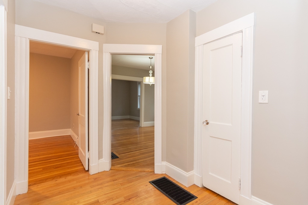39 Gould Street, Unit A Wakefield, MA 01880 - Photo 26 of 32 a view of a hallway with wooden floor and closet