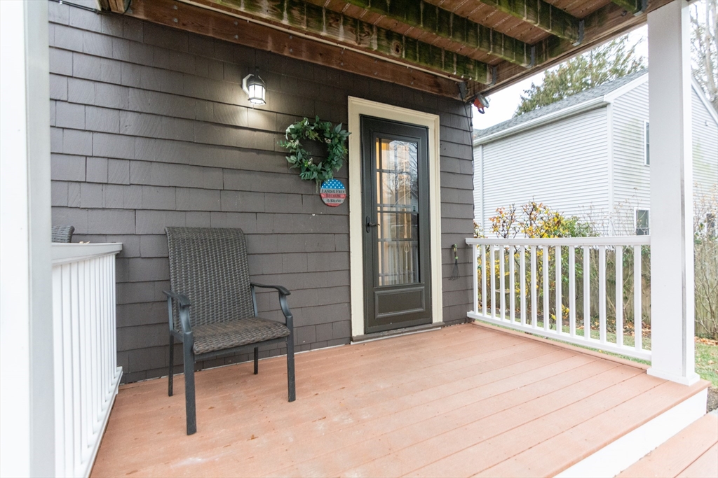 39 Gould Street, Unit A Wakefield, MA 01880 - Photo 29 of 32 a view of a porch with wooden floor and stairs