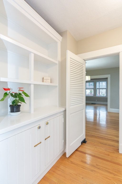 39 Gould Street, Unit A Wakefield, MA 01880 - Photo 9 of 32 a view of a hallway with wooden floor and cabinet
