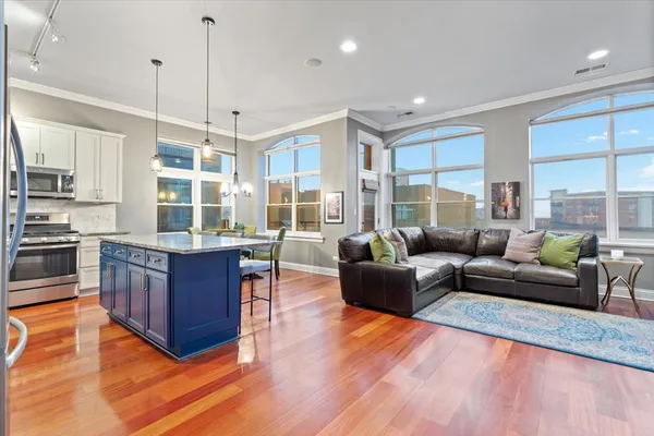 a living room with furniture and a wooden floor