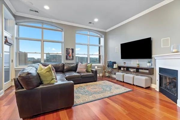 a living room with fireplace furniture and a flat screen tv