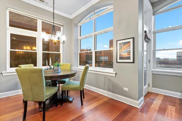 a view of a dining room with furniture and wooden floor