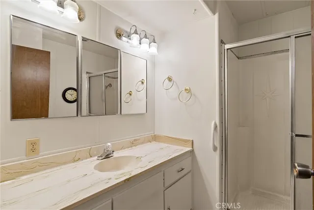 a bathroom with a granite countertop sink mirror and double