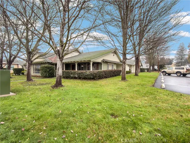 a view of a house with a backyard