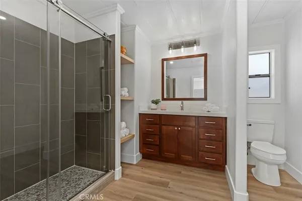 a bathroom with a granite countertop sink a toilet and shower