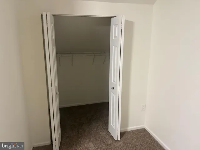 a bathroom with a sink a toilet a mirror and shower