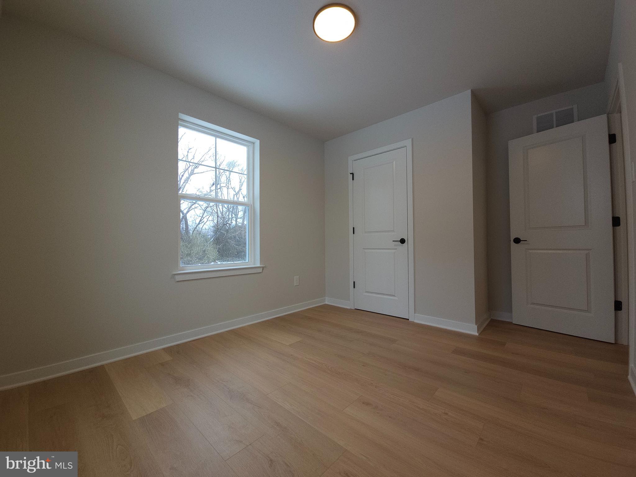 10 Fieldstone Court Bridgeton, NJ 08302 - Photo 15 of 31 an empty room with wooden floor and windows