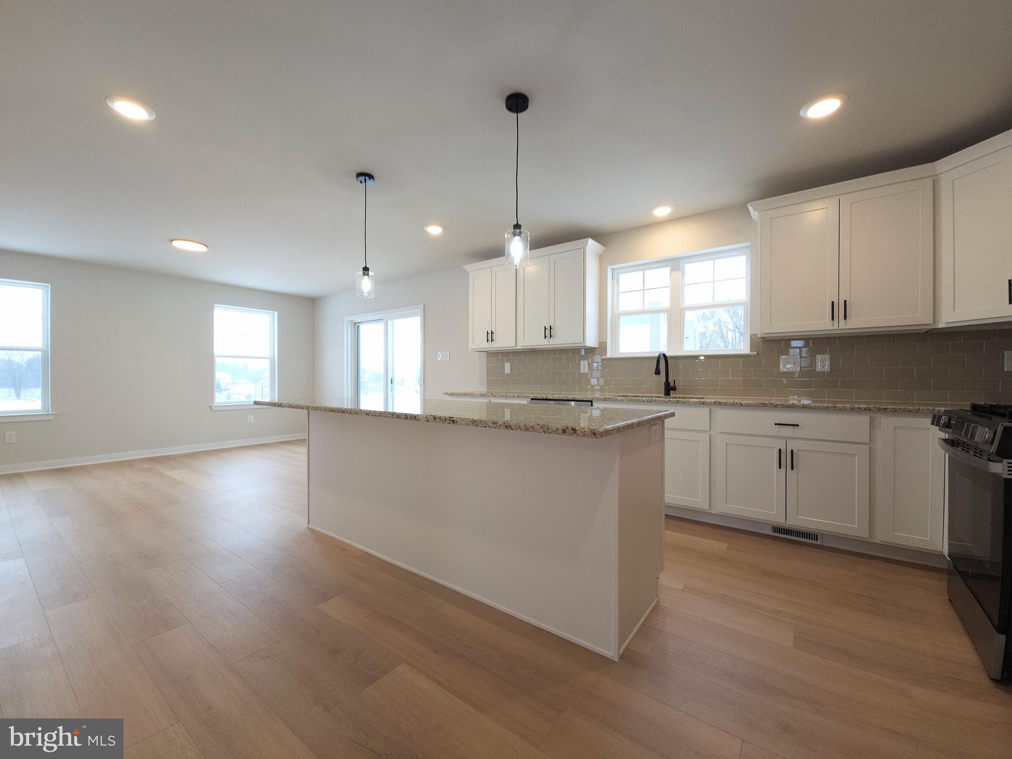 10 Fieldstone Court Bridgeton, NJ 08302 - Photo 9 of 31 a kitchen with stainless steel appliances granite countertop a sink a stove a refrigerator and white cabinets with wooden floor