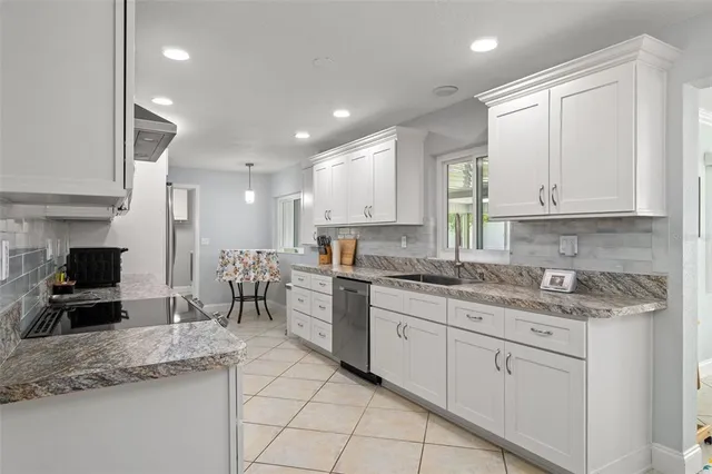 a kitchen with a sink stove and cabinets