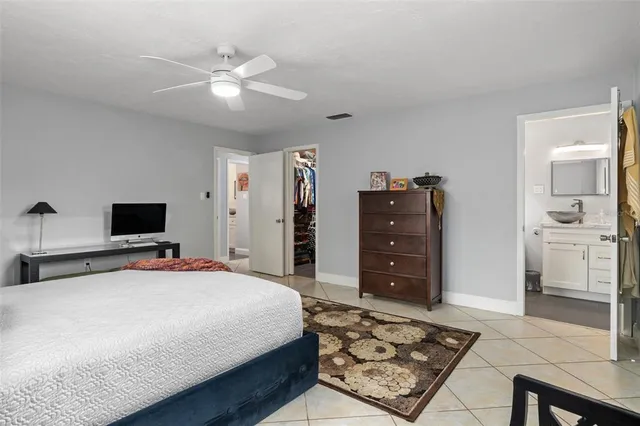 a bedroom with a bed and a television