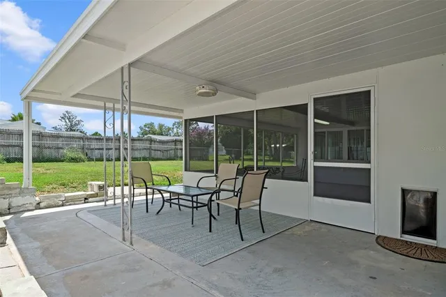 a view of a patio with a backyard table and chairs