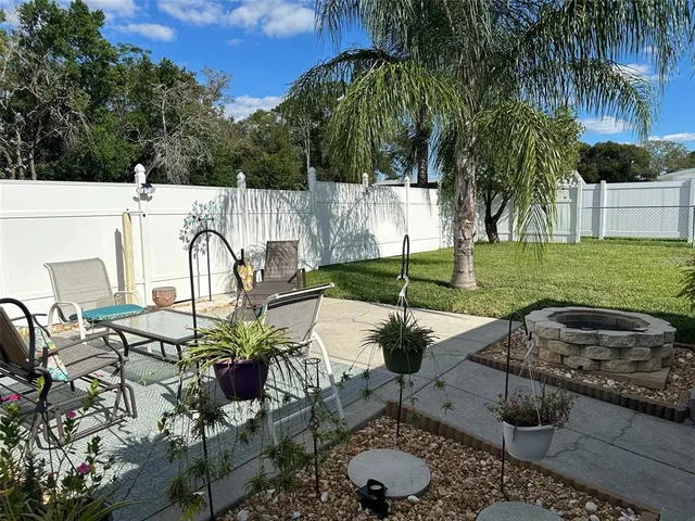 a view of a backyard with plants and patio