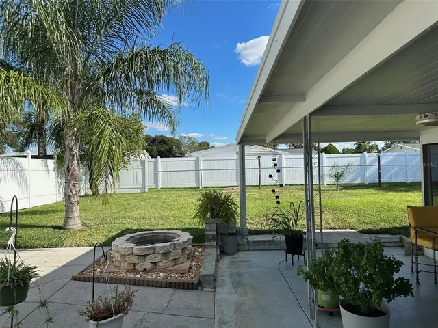 a car parked in front of a house with a garden
