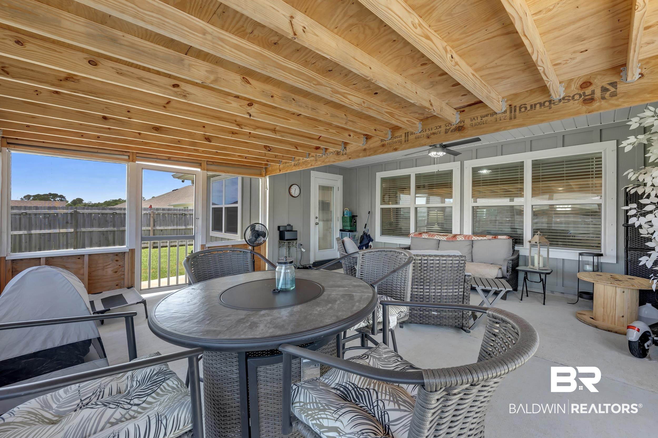 24271 Ringneck Loop Elberta, AL 36530 - Photo 30 of 44 Expansive screened porch featuring a finished concrete floor and an exposed wood beam ceiling