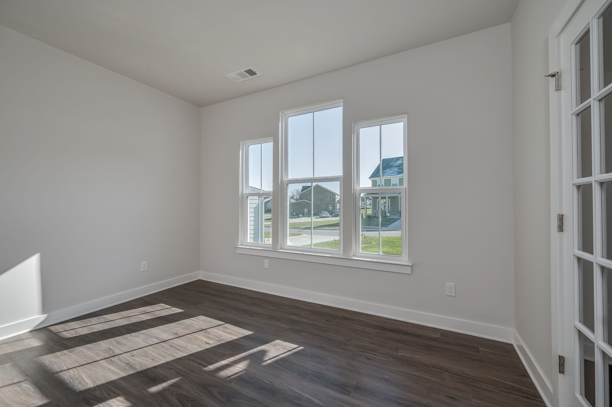 9016 Nestling Ridge College Grove, TN 37046 - Photo 17 of 30 a view of an empty room with wooden floor and a window