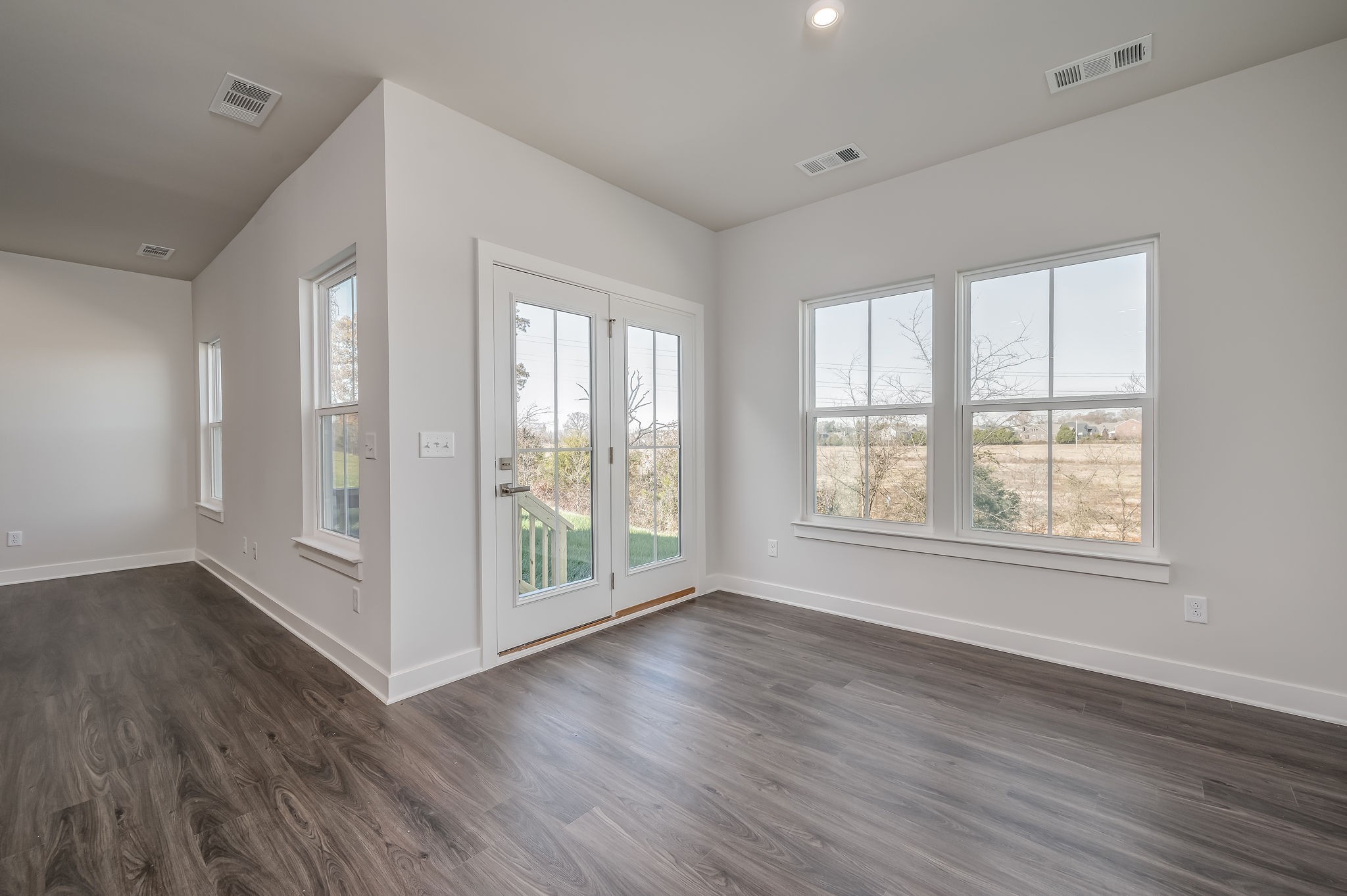 9016 Nestling Ridge College Grove, TN 37046 - Photo 21 of 30 a view of an empty room with wooden floor and a window