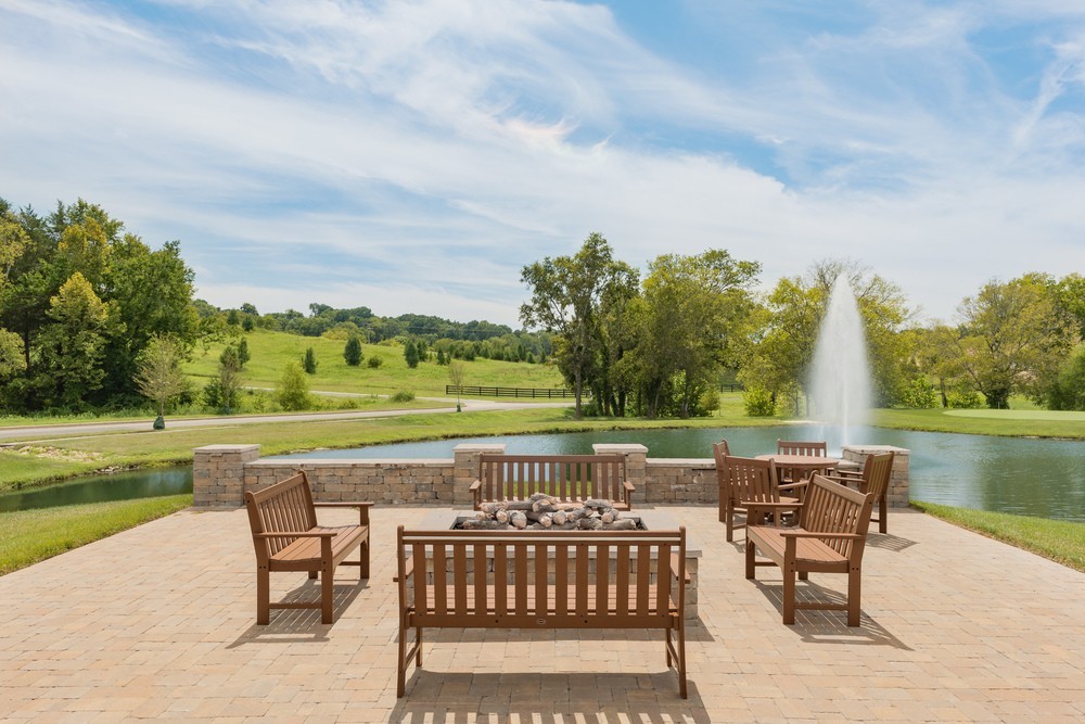 9016 Nestling Ridge College Grove, TN 37046 - Photo 6 of 30 an outdoor view of a lake with a table and a chairs