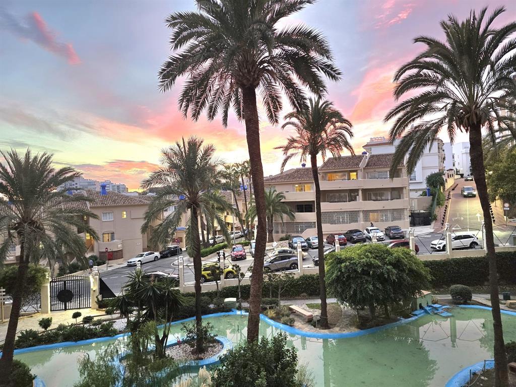 a backyard of a house with outdoor seating and lake view