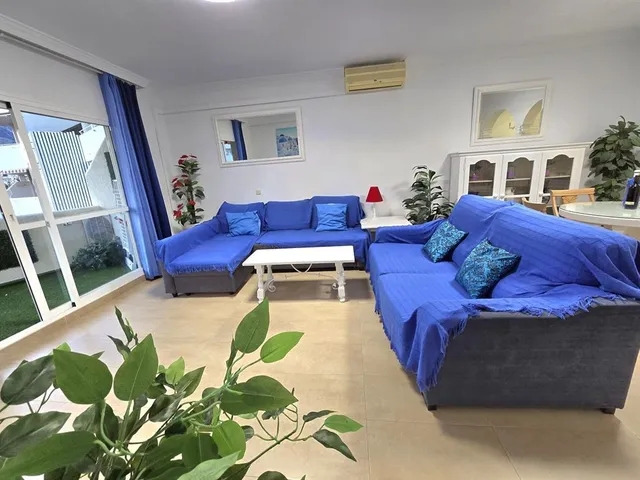 a living room with furniture fireplace and rug