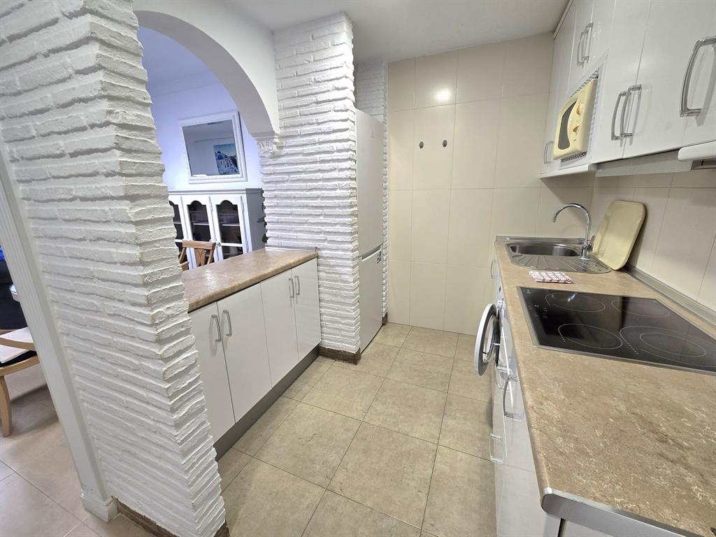 Benalmadena-malaga Av Del Parque3 Torre1 Planta7, Unit 701 Blackstock, 0 29014 - Photo 16 of 33 a kitchen with stainless steel appliances granite countertop a white stove top oven a sink and dishwasher