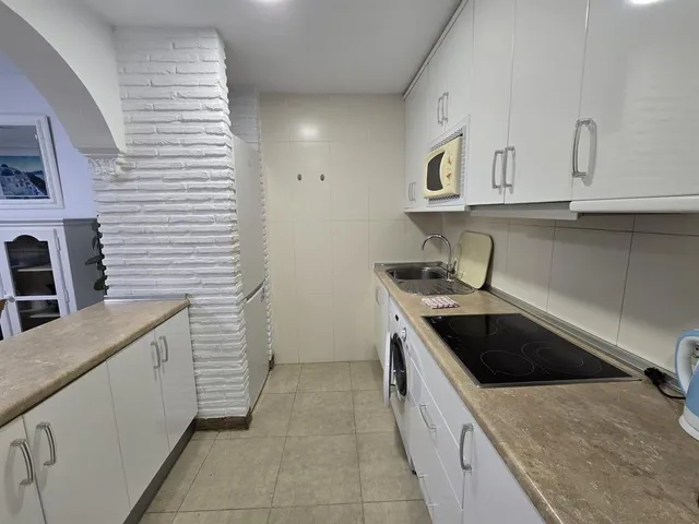 a kitchen with stainless steel appliances granite countertop a sink and dishwasher a stove top oven with wooden floor