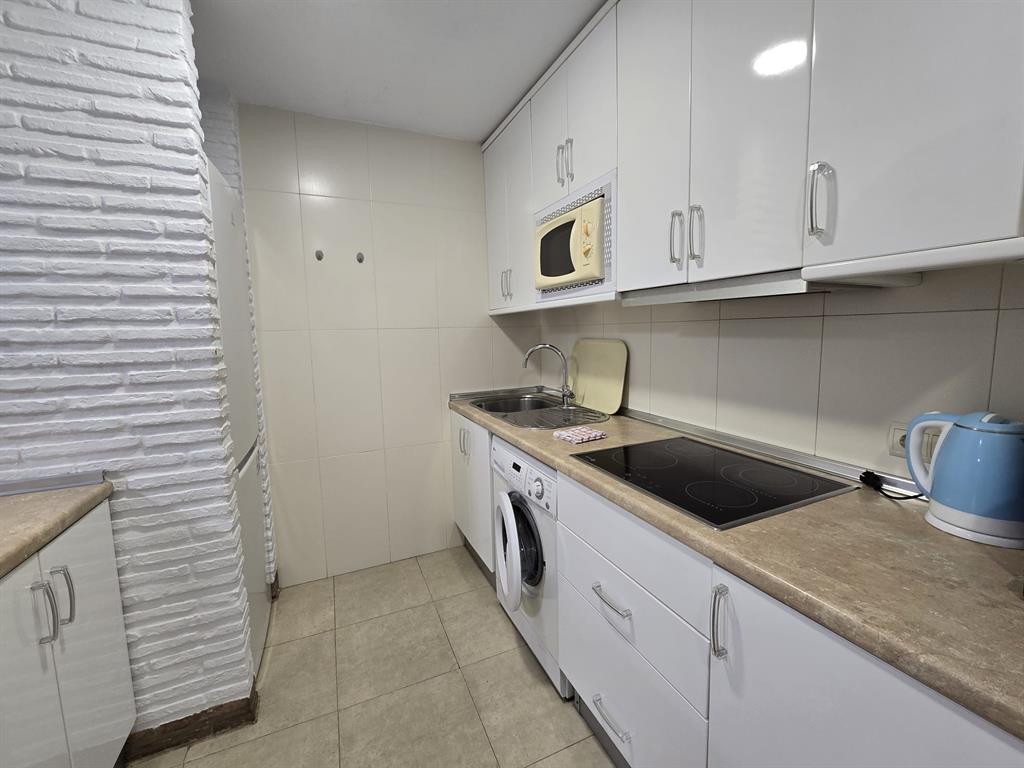 Benalmadena-malaga Av Del Parque3 Torre1 Planta7, Unit 701 Blackstock, 0 29014 - Photo 19 of 33 a kitchen with granite countertop white cabinets and white appliances