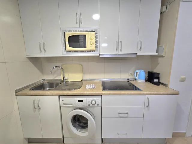 a kitchen with stainless steel appliances granite countertop a sink a stove and cabinets