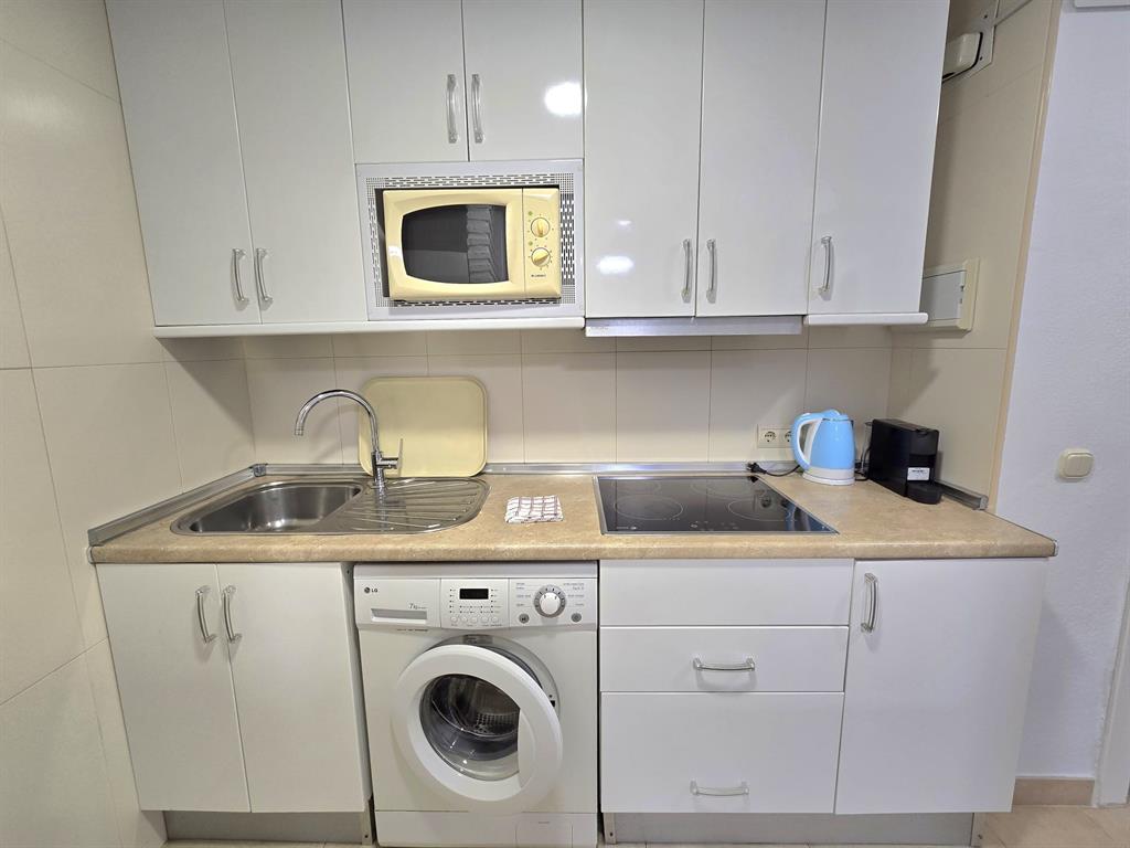 Benalmadena-malaga Av Del Parque3 Torre1 Planta7, Unit 701 Blackstock, 0 29014 - Photo 20 of 33 a kitchen with stainless steel appliances granite countertop a sink a stove and cabinets