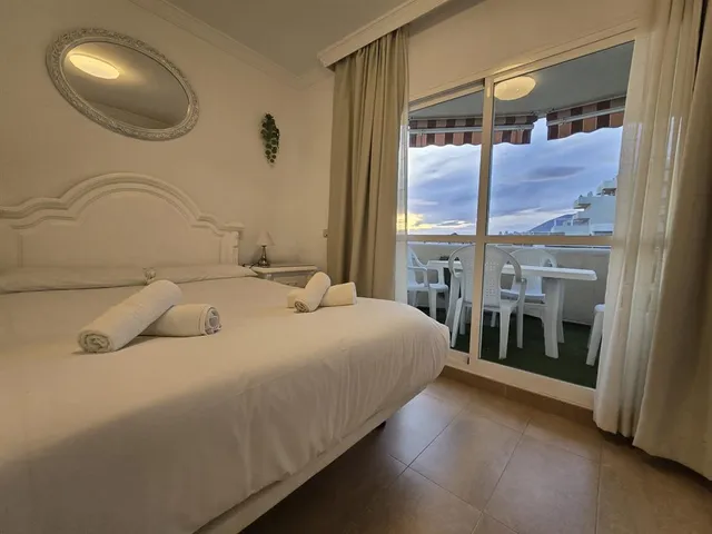 a bedroom with a large bed and a large window