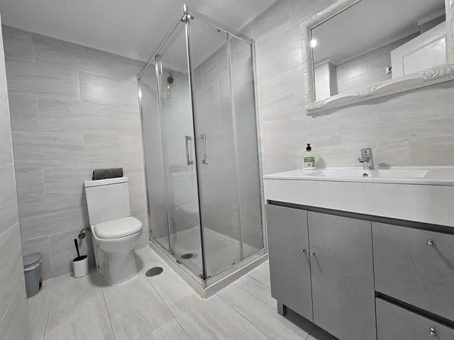 a bathroom with a toilet sink and shower